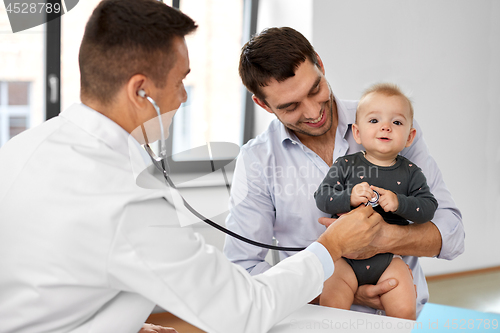 Image of father with baby and doctor at clinic