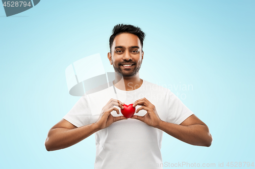 Image of indian man with red heart over blue background