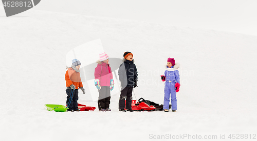 Image of happy little kids with sleds in winter