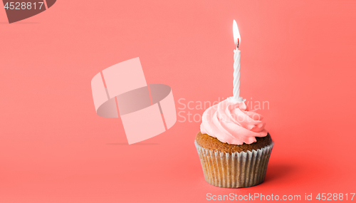 Image of birthday cupcake with one burning candle