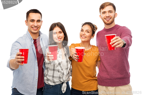 Image of group of smiling friends with drinks in party cups