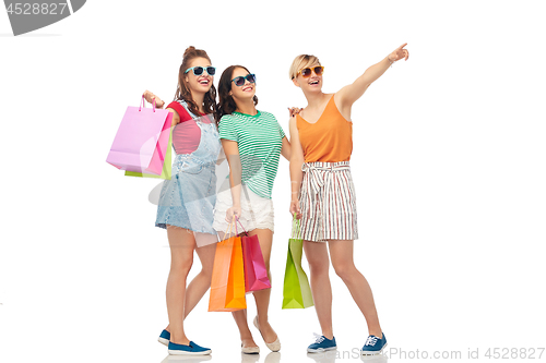 Image of happy female friends with shopping bags