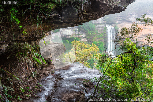 Image of Natures window to a waterfall viewed through the cliff ledge