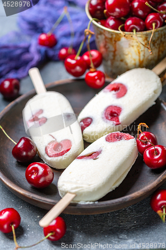 Image of Homemade vanilla ice cream with cherry.