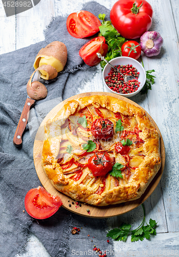 Image of Traditional pie (Galette) with potatoes and bacon.