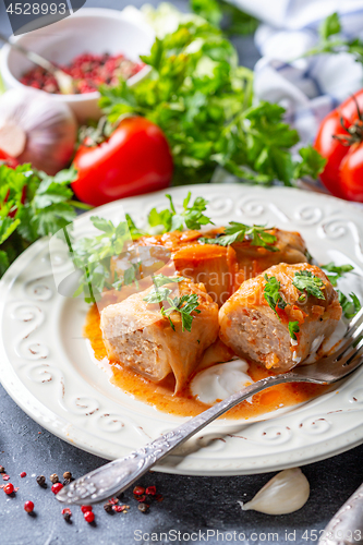 Image of Cabbage rolls stuffed with ground beef and rice.