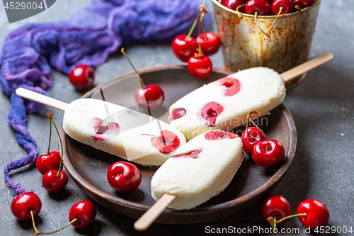 Image of Artisanal vanilla ice cream with cherry.