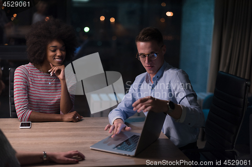 Image of Multiethnic startup business team in night office