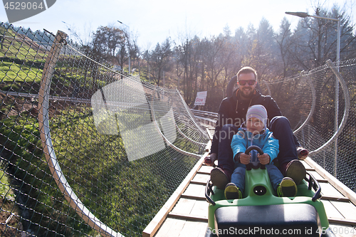 Image of father and son enjoys driving on alpine coaster