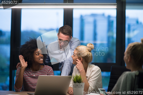 Image of Multiethnic startup business team in night office