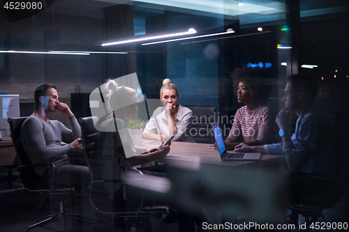 Image of Multiethnic startup business team in night office