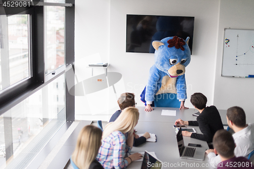 Image of boss dresed as bear having fun with business people in trendy of