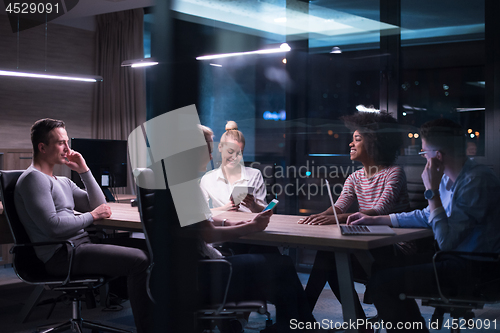 Image of Multiethnic startup business team in night office