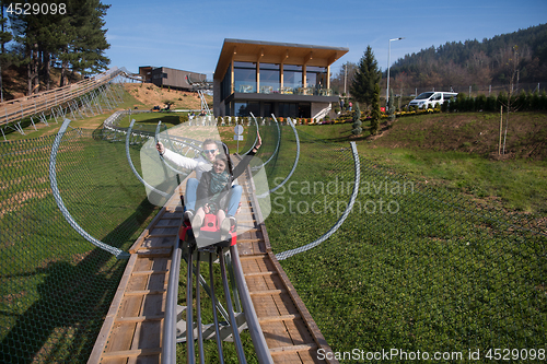 Image of couple enjoys driving on alpine coaster