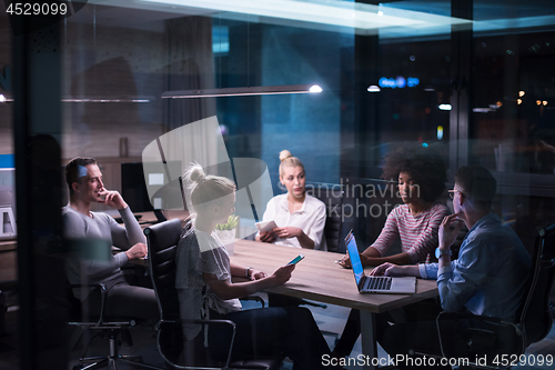 Image of Multiethnic startup business team in night office