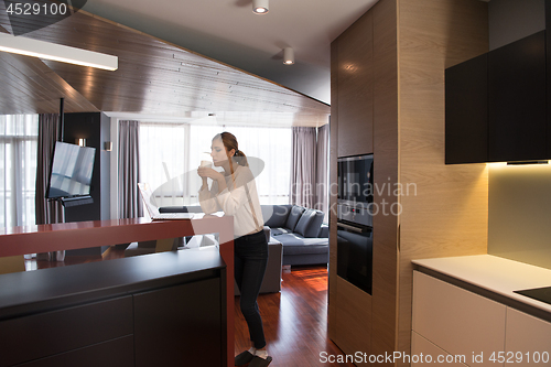 Image of woman drinking coffee enjoying relaxing lifestyle