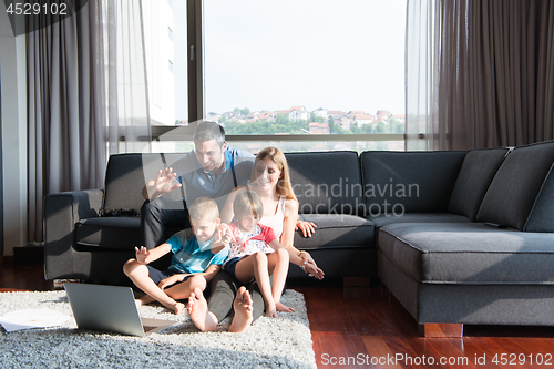 Image of Family Playing Together with laptop computer