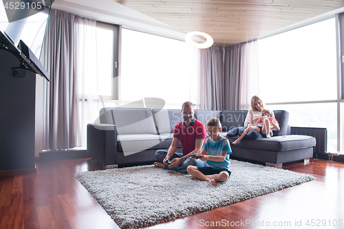 Image of Happy family playing a video game