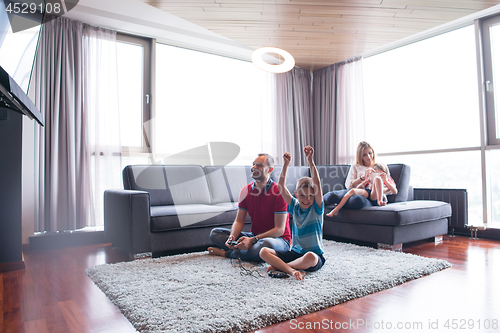 Image of Happy family playing a video game