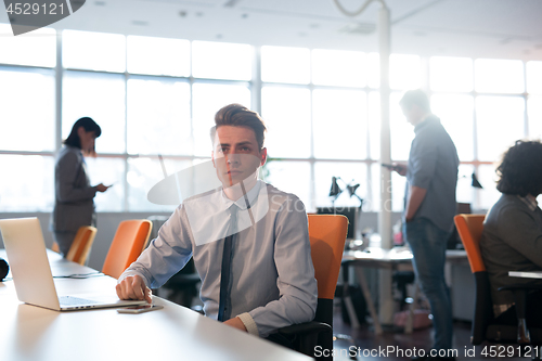 Image of businessman working using a laptop in startup office