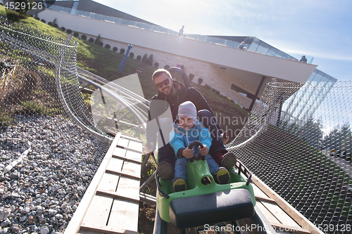 Image of father and son enjoys driving on alpine coaster