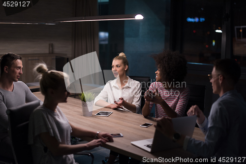 Image of Multiethnic startup business team in night office