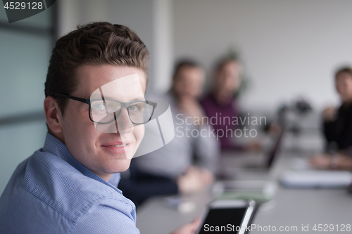 Image of Businessman using tablet in modern office