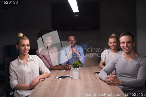 Image of Multiethnic startup business team in night office