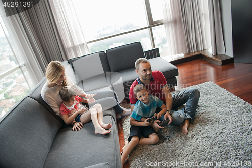 Image of Happy family playing a video game