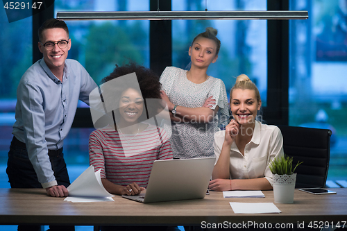 Image of Multiethnic startup business team in night office