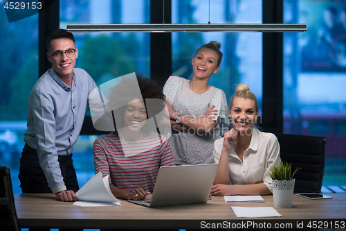 Image of Multiethnic startup business team in night office