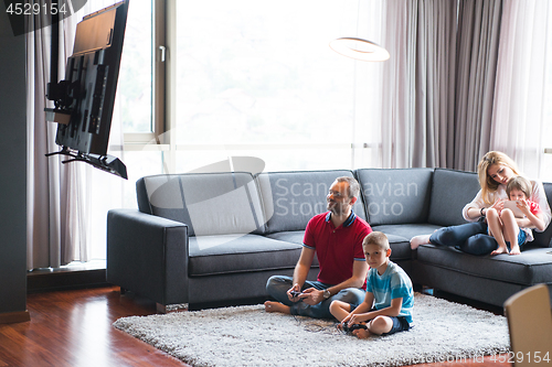 Image of Happy family playing a video game