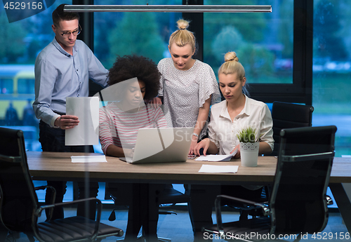 Image of Multiethnic startup business team in night office