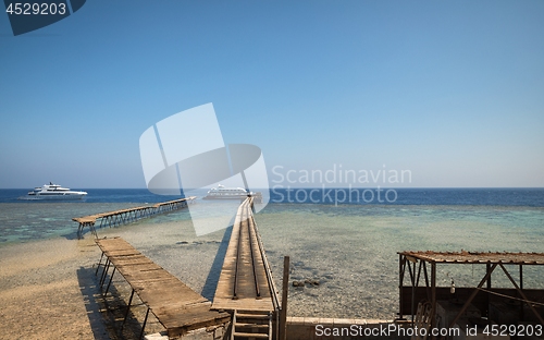 Image of Long pier with some yachts