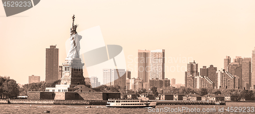 Image of Statue of Liberty with Liberty State Park and Jersey City skyscrapers in background, USA