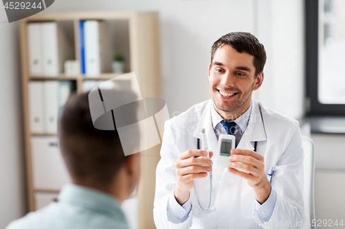 Image of doctor with glucometer and patient at hospital