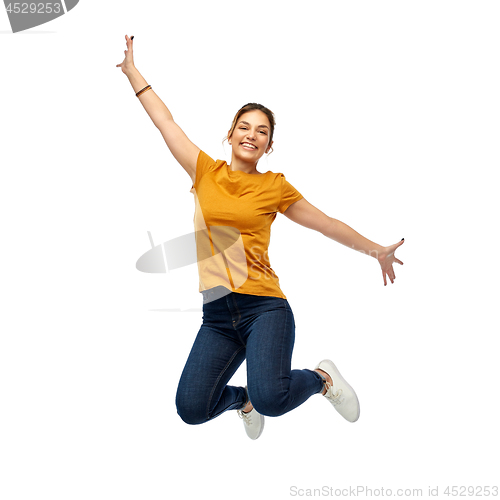 Image of happy young woman or teenage girl jumping