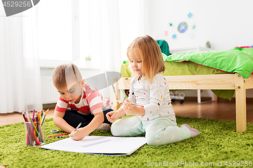 Image of happy kids drawing at home