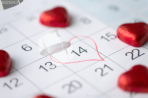 Image of close up of calendar and heart shaped candies