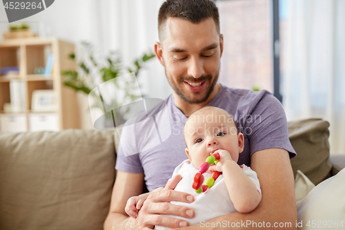 Image of happy father with little baby daughter at home