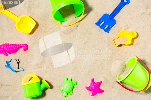 Image of close up of sand toys kit on summer beach