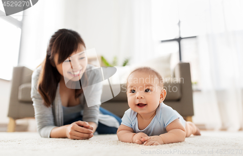 Image of sweet little asian baby boy with mother at home