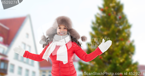 Image of happy woman over christmas tree in tallinn