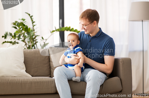 Image of happy father with baby son at home