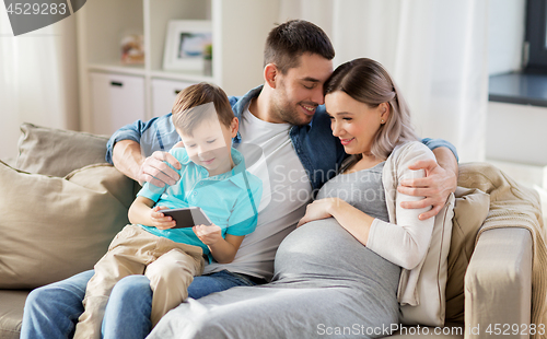 Image of happy family with smartphone at home