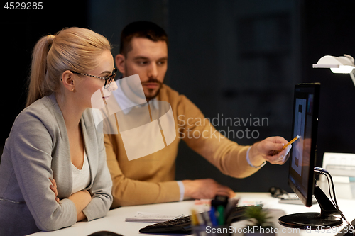 Image of designers with mockup on computer screen at office