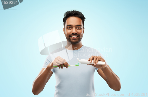 Image of indian man with toothbrush and toothpaste