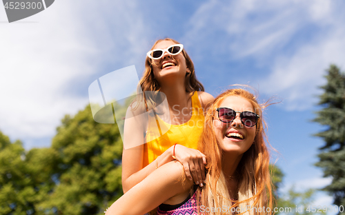 Image of happy teenage girls having fun at summer park