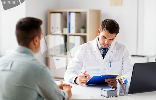 Image of doctor with clipboard and male patient at hospital