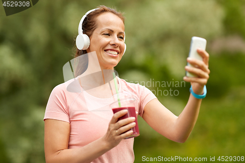 Image of woman with smartphone and shake listening to music